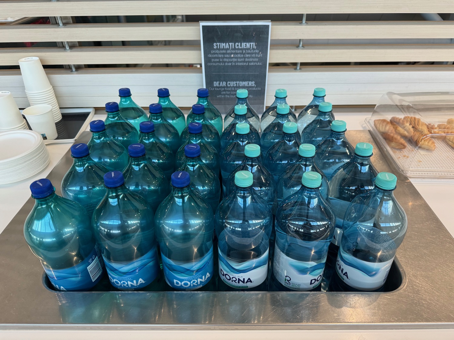 a group of bottles of water in a sink