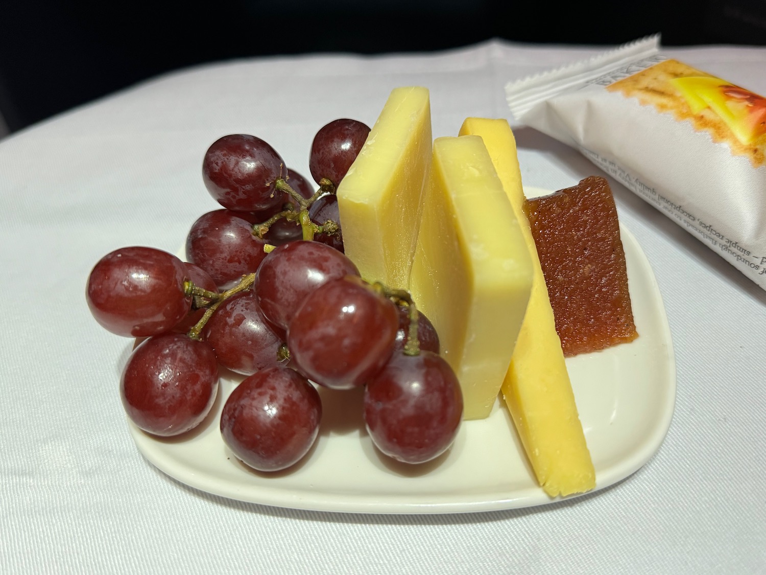 a plate of cheese and grapes