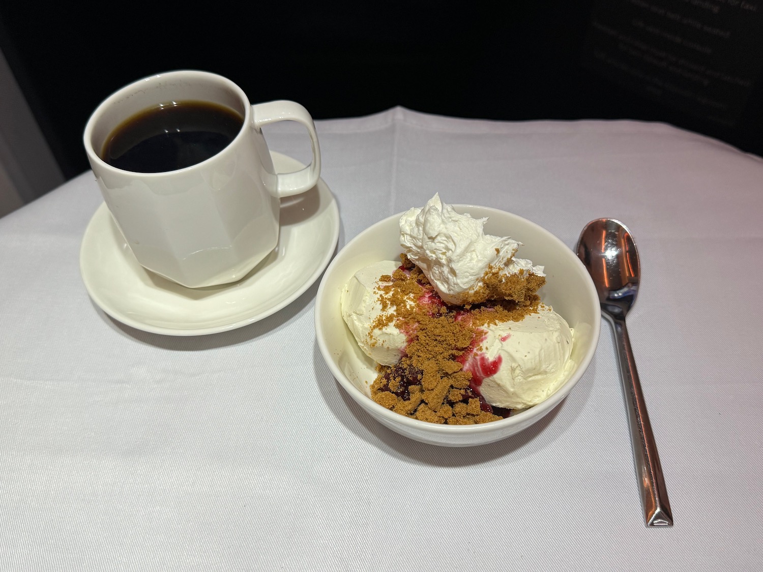 a cup of coffee and dessert on a table
