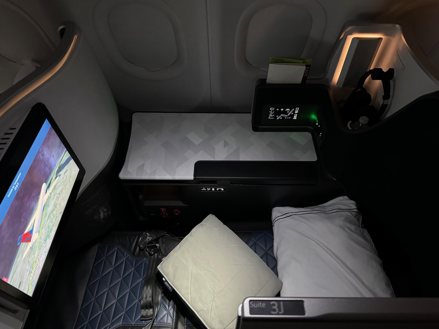 a seat with a bed and a monitor