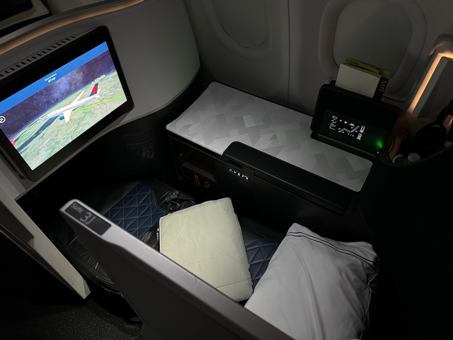 a seat with a tv and a monitor in the back of a plane