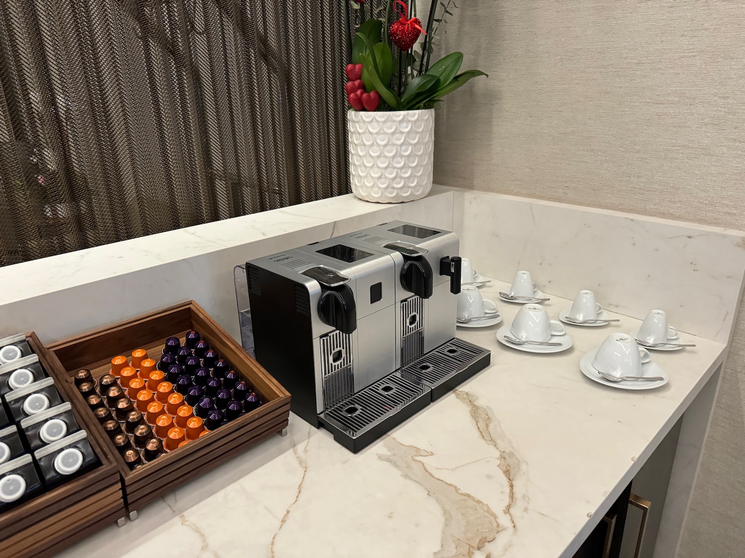 a coffee machine and cups on a counter