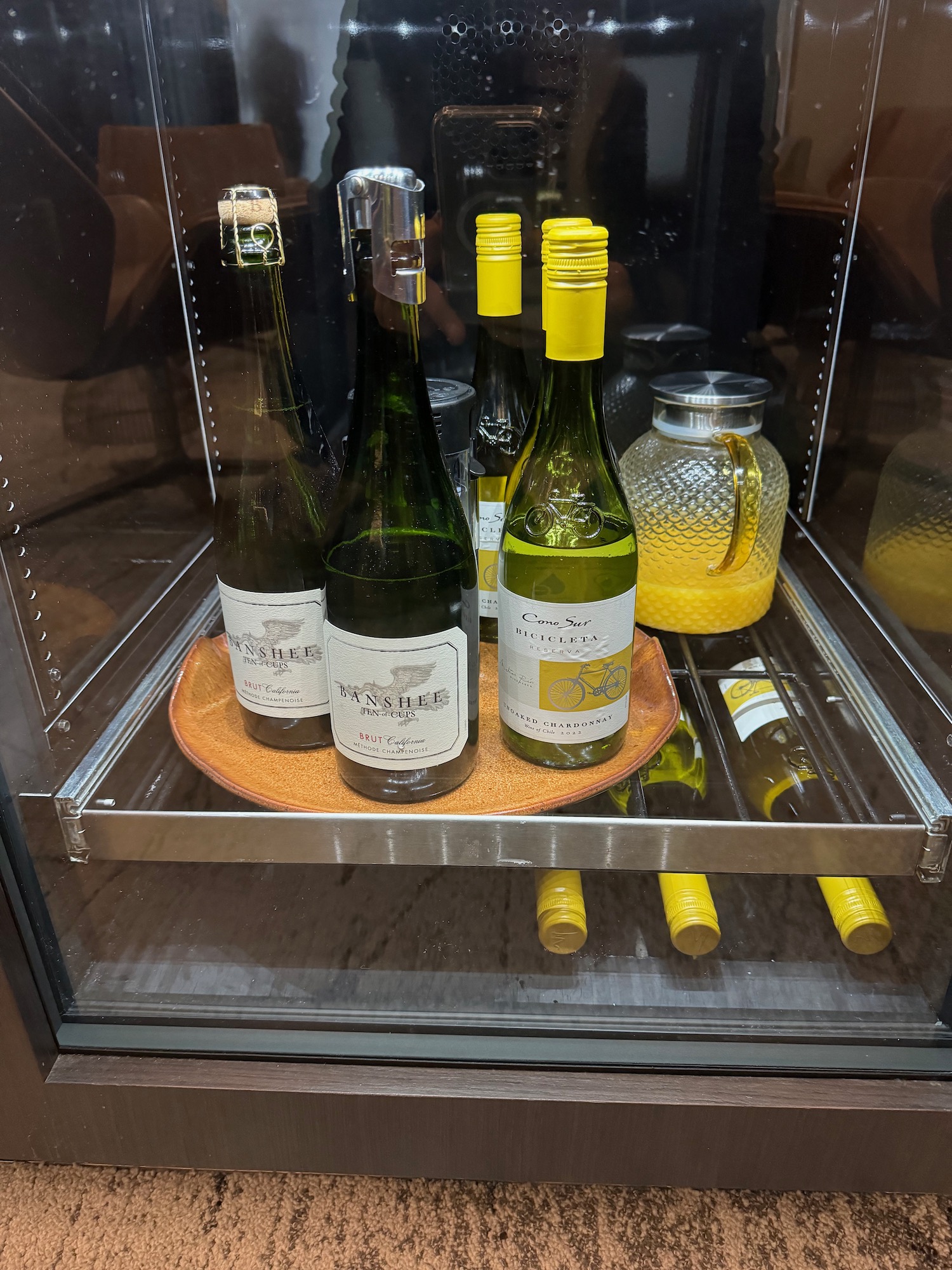 a glass case with bottles on it