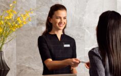 a woman handing a business card to a woman