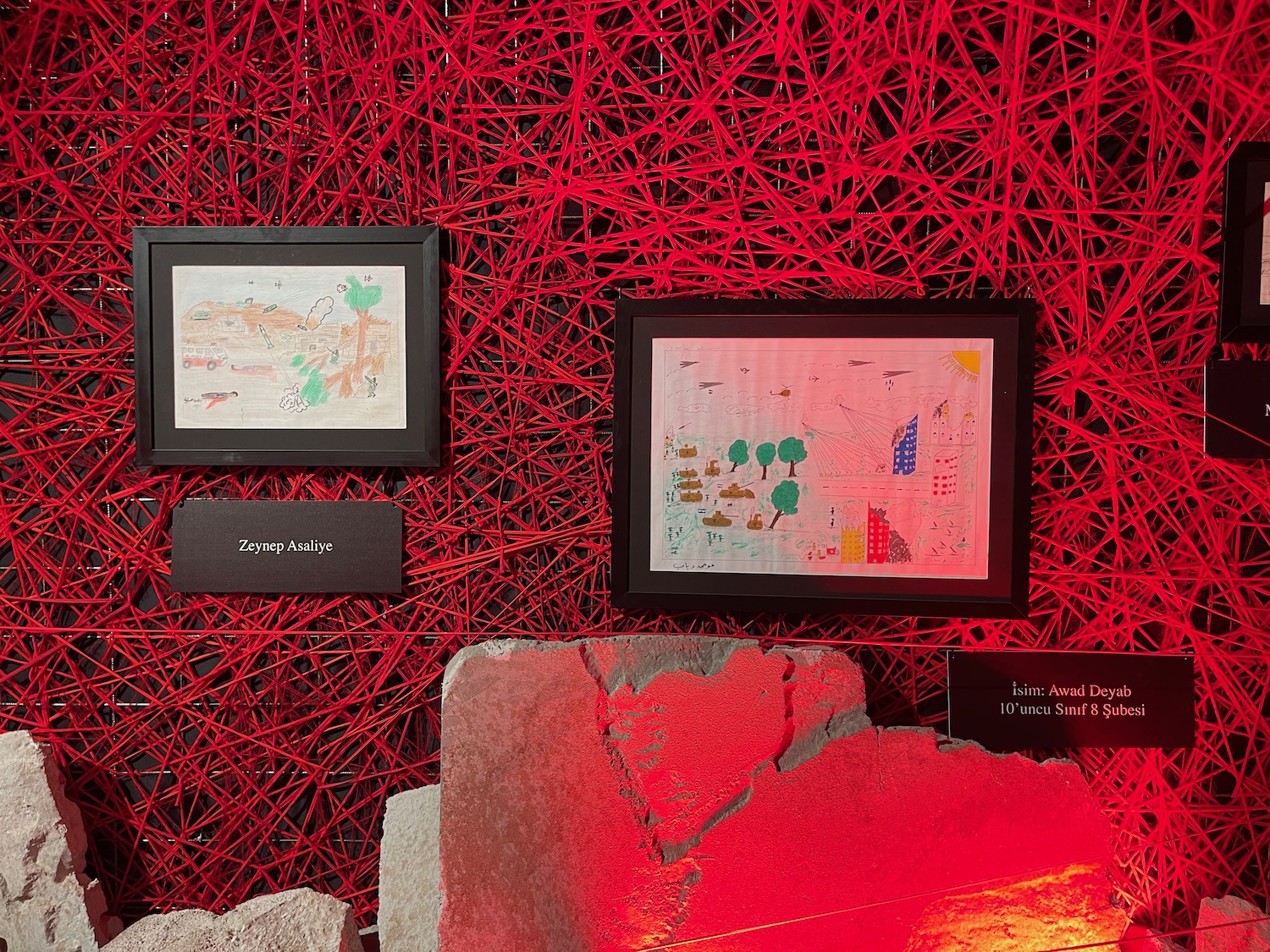 a framed maps on a red wall