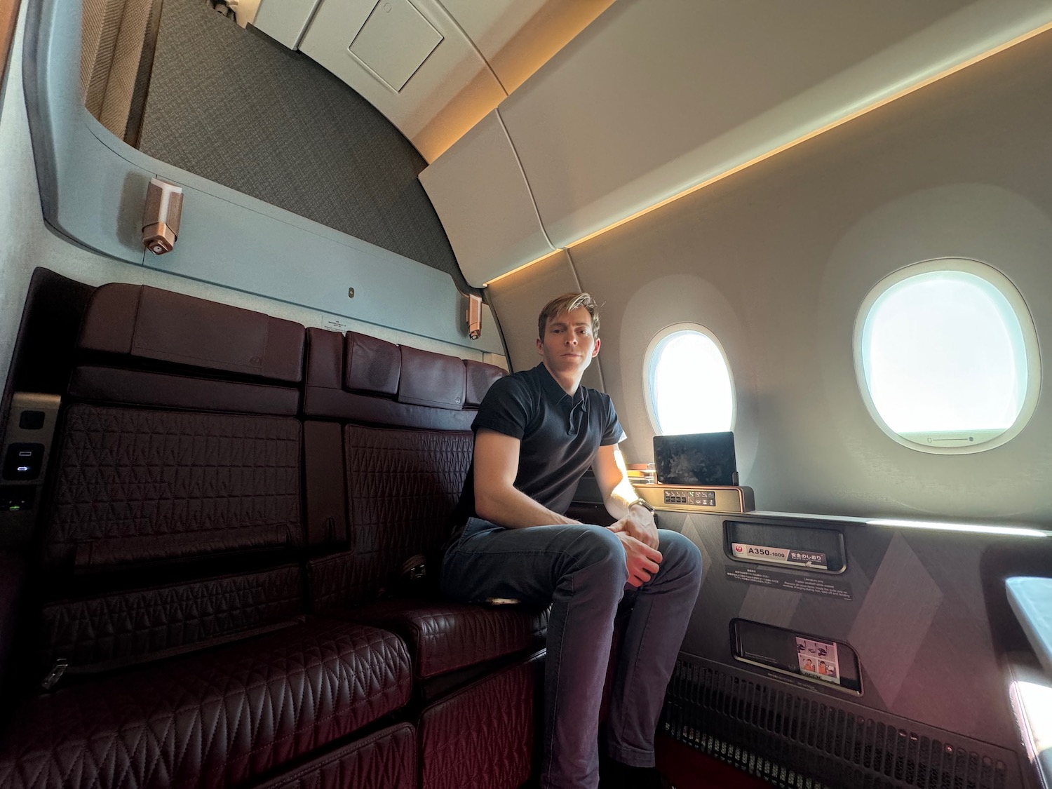 a man sitting on a seat in an airplane