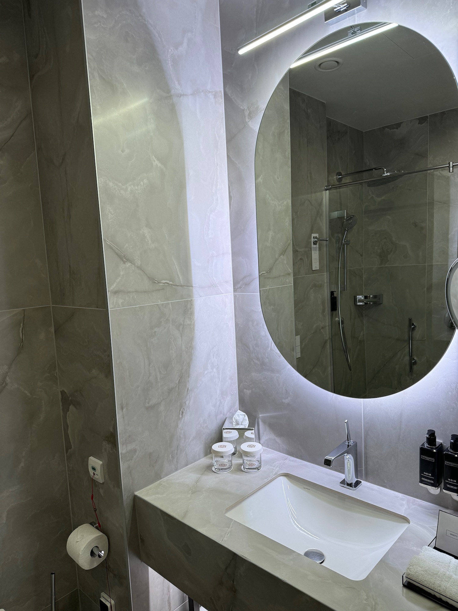 a bathroom with a round mirror