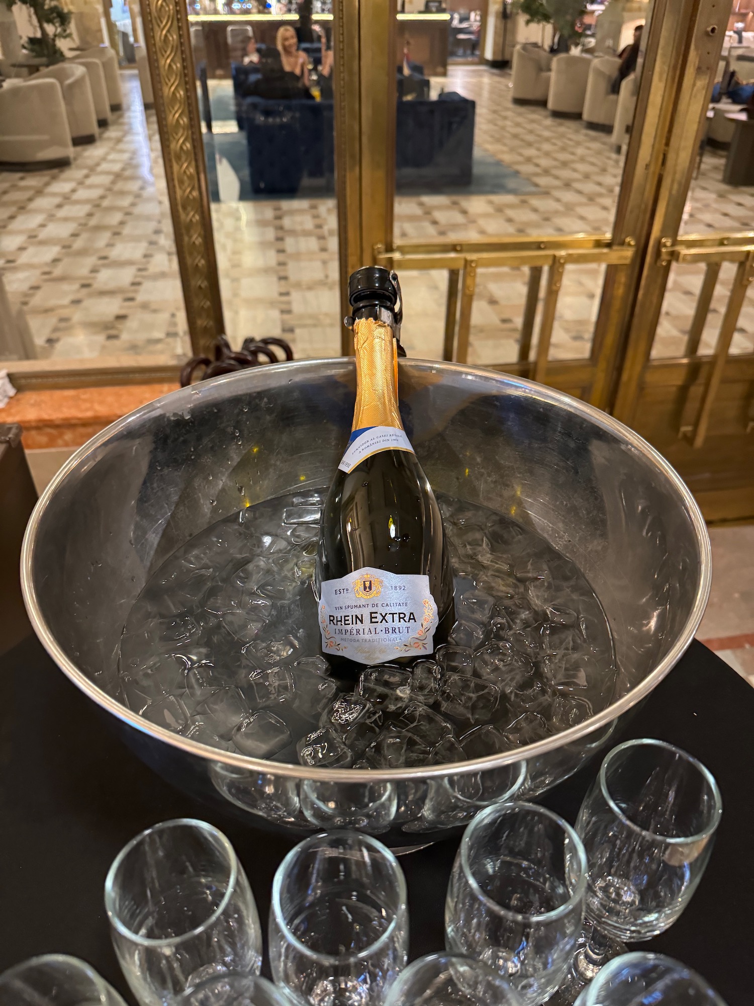 a bottle of champagne in a bowl of ice