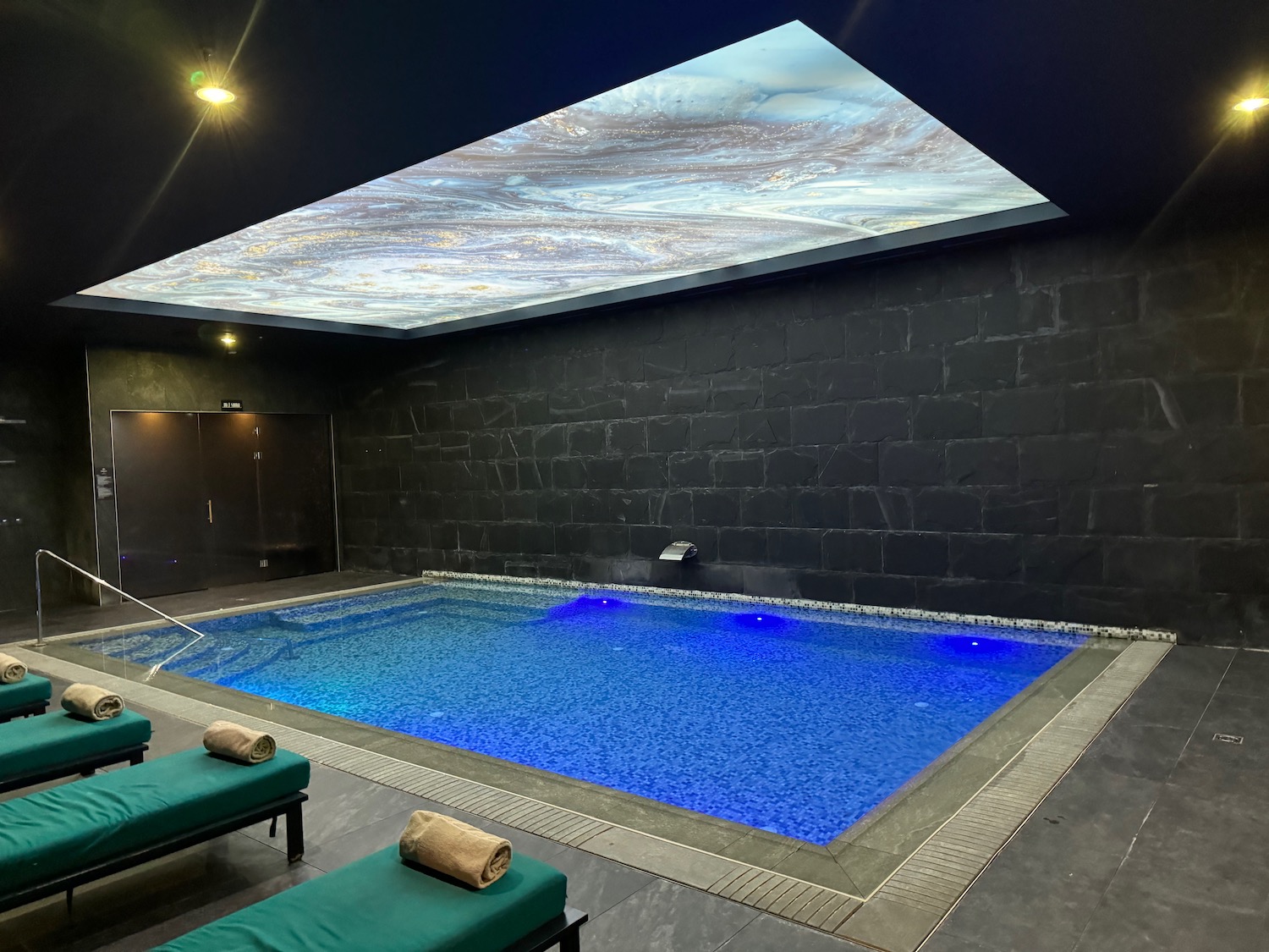 a pool with a large ceiling and a large skylight