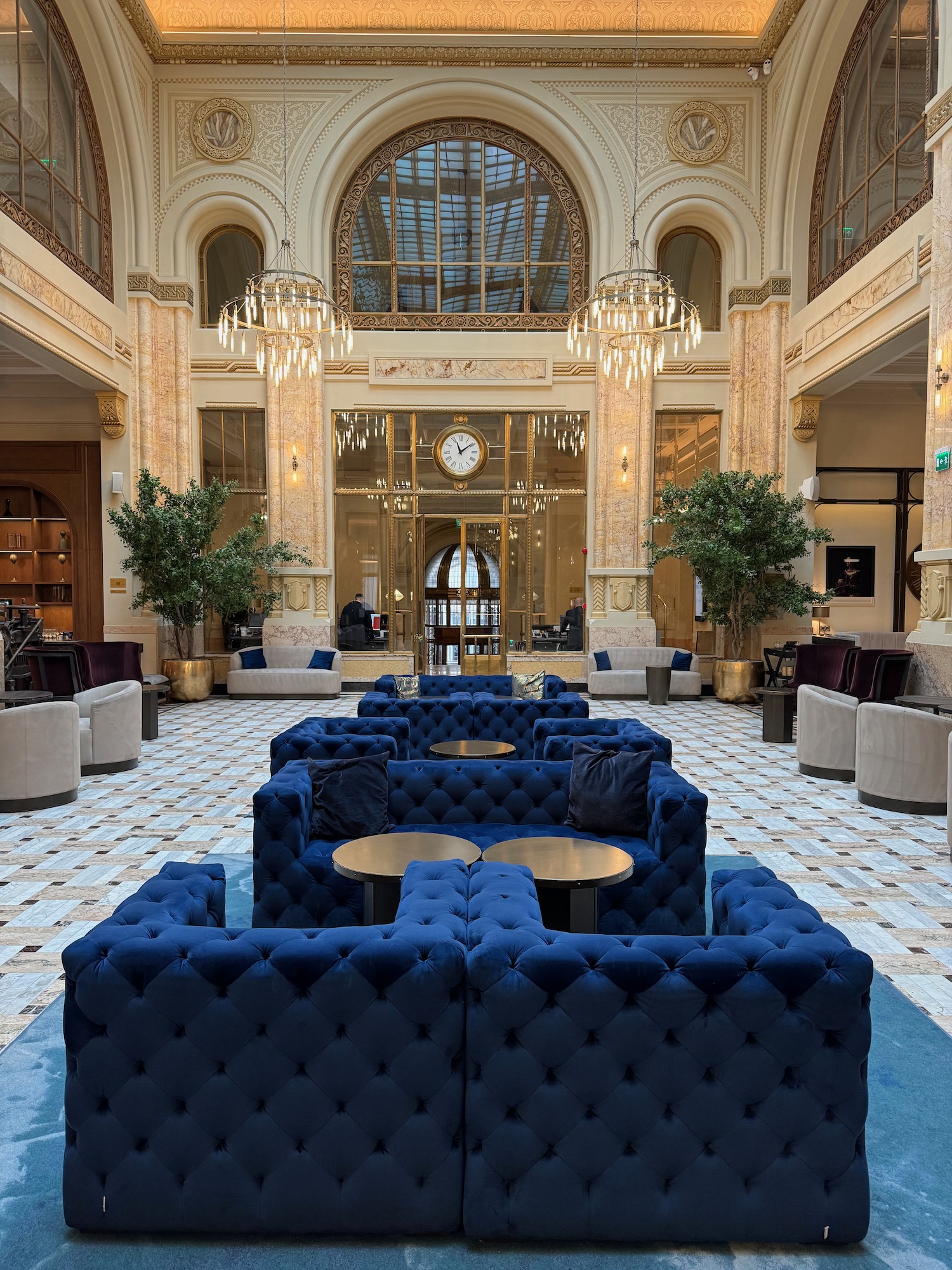 a large room with blue couches and tables