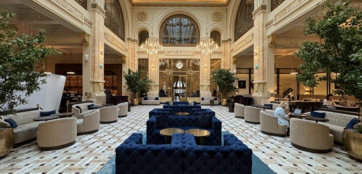 a large room with blue couches and tables