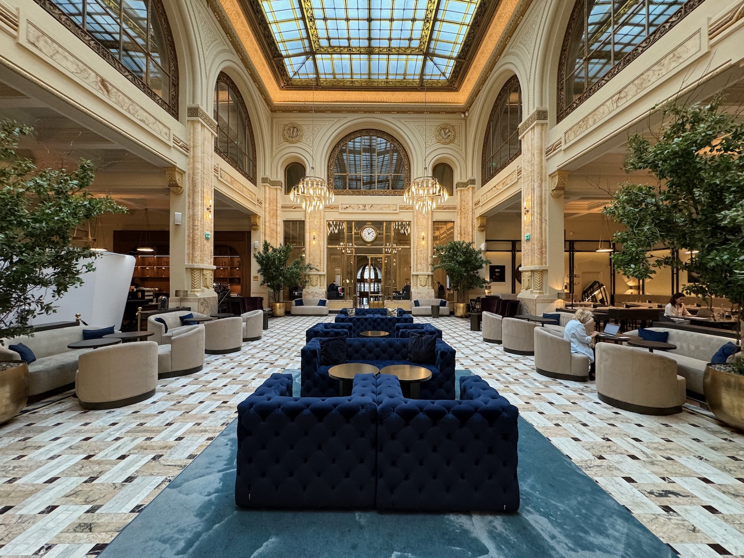 a large room with blue couches and tables