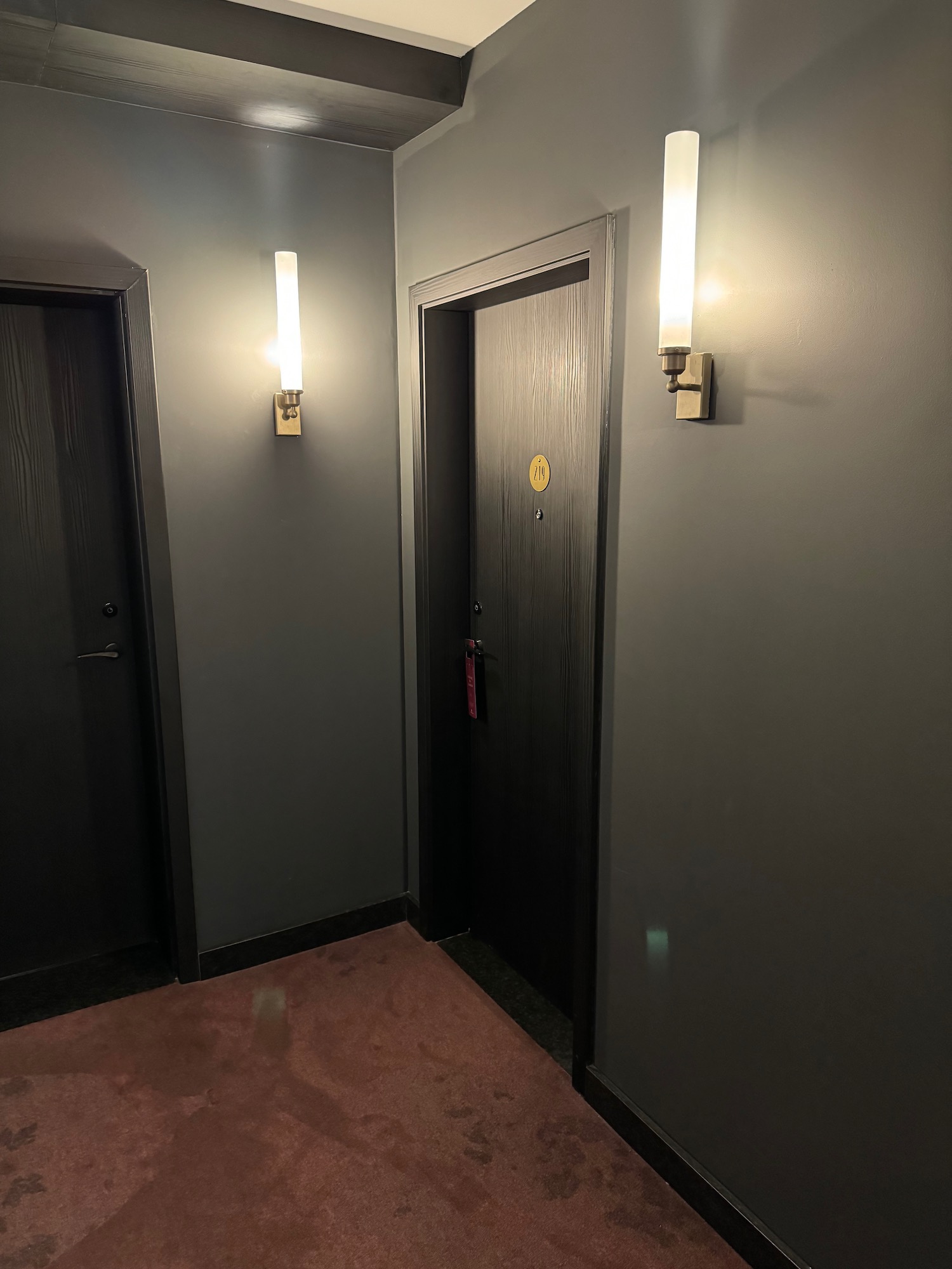 a door and two lights in a hallway