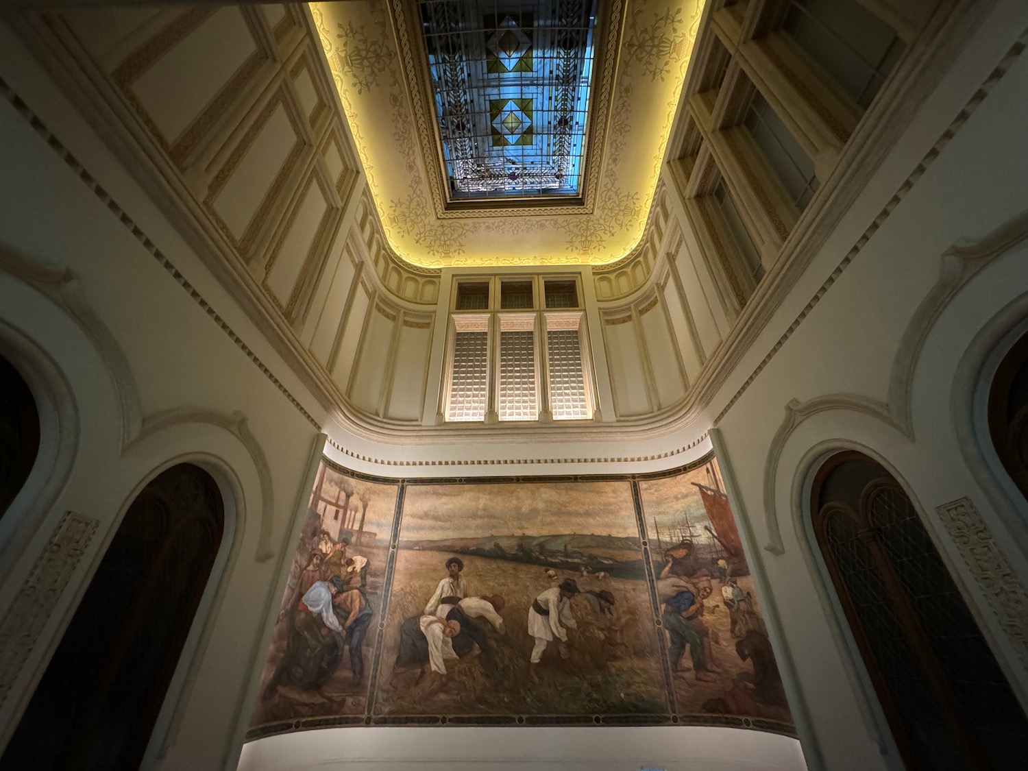a ceiling with a painting on the wall