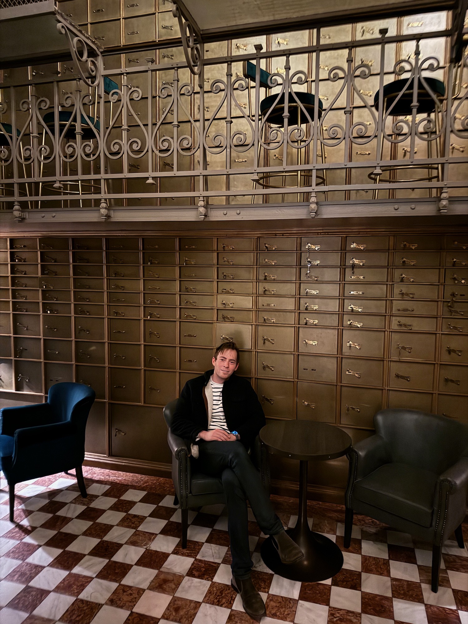 a man sitting in a chair in front of a cabinet