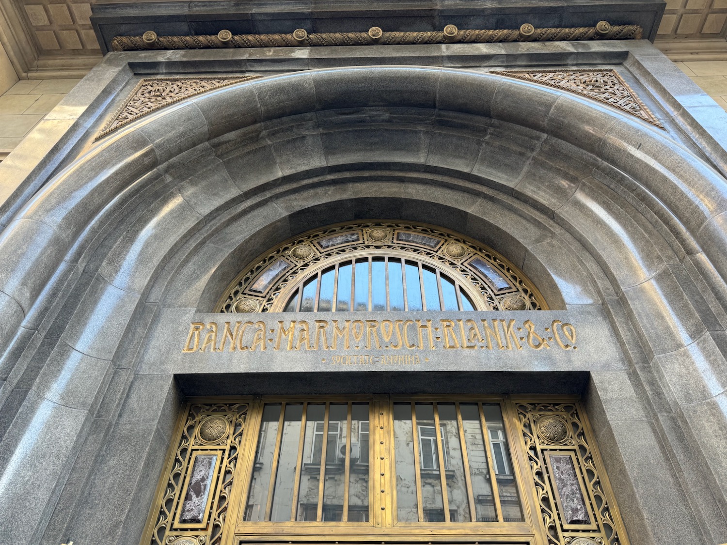 a stone building with a gold door