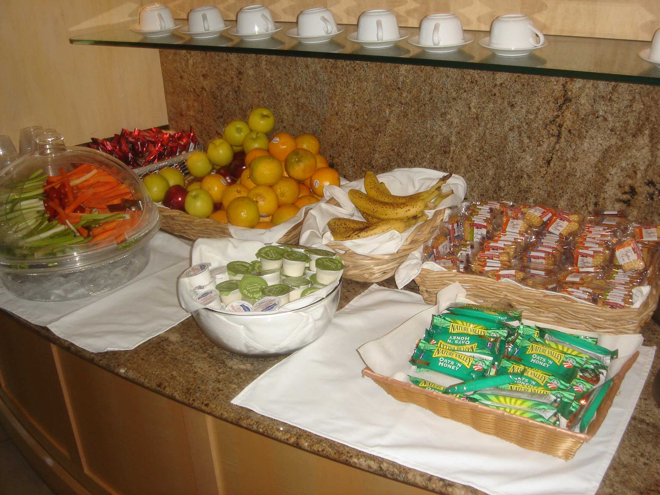 a buffet table with fruit and candy