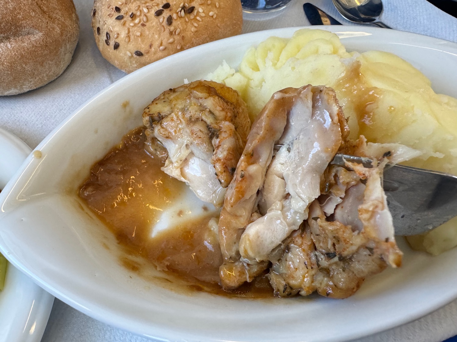a plate of food with bread and spoons