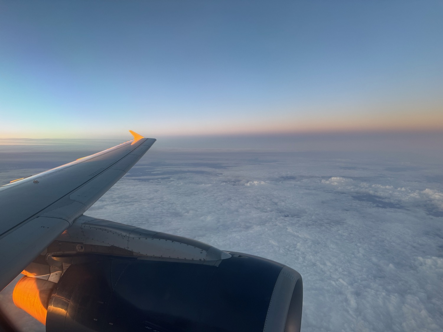 an airplane wing above the clouds