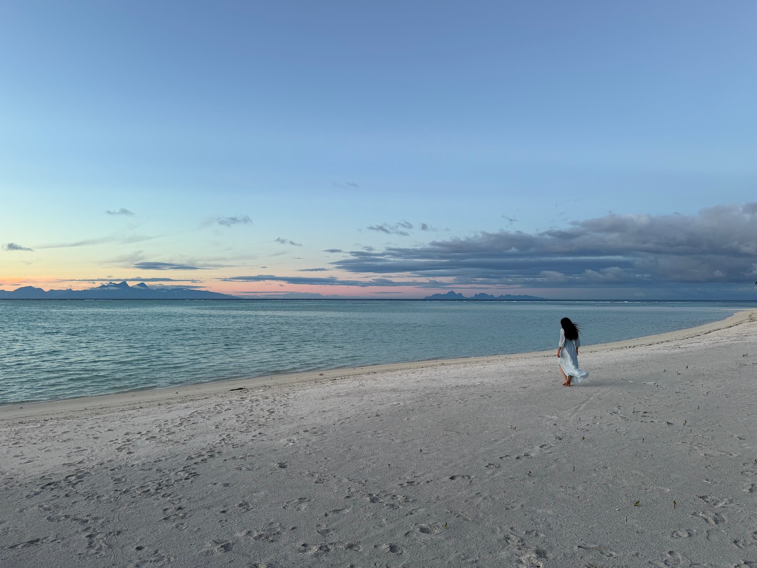 a woman walking on a beach