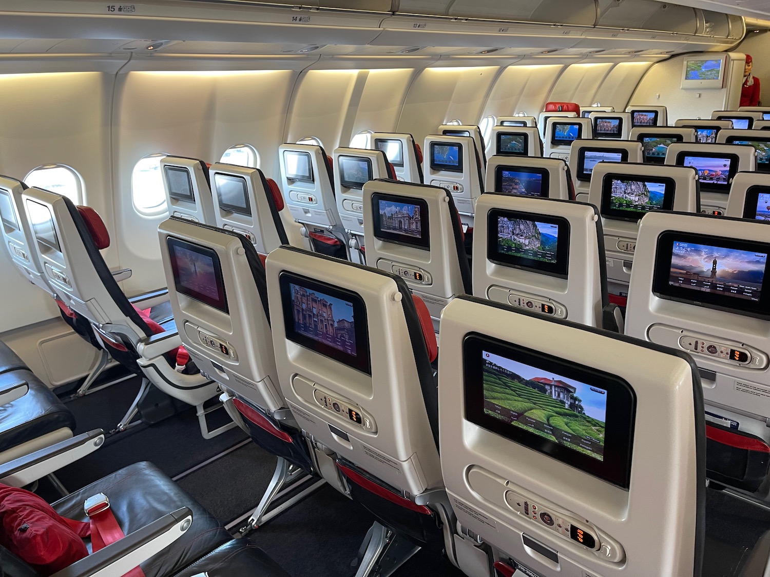 a row of seats with monitors on the side