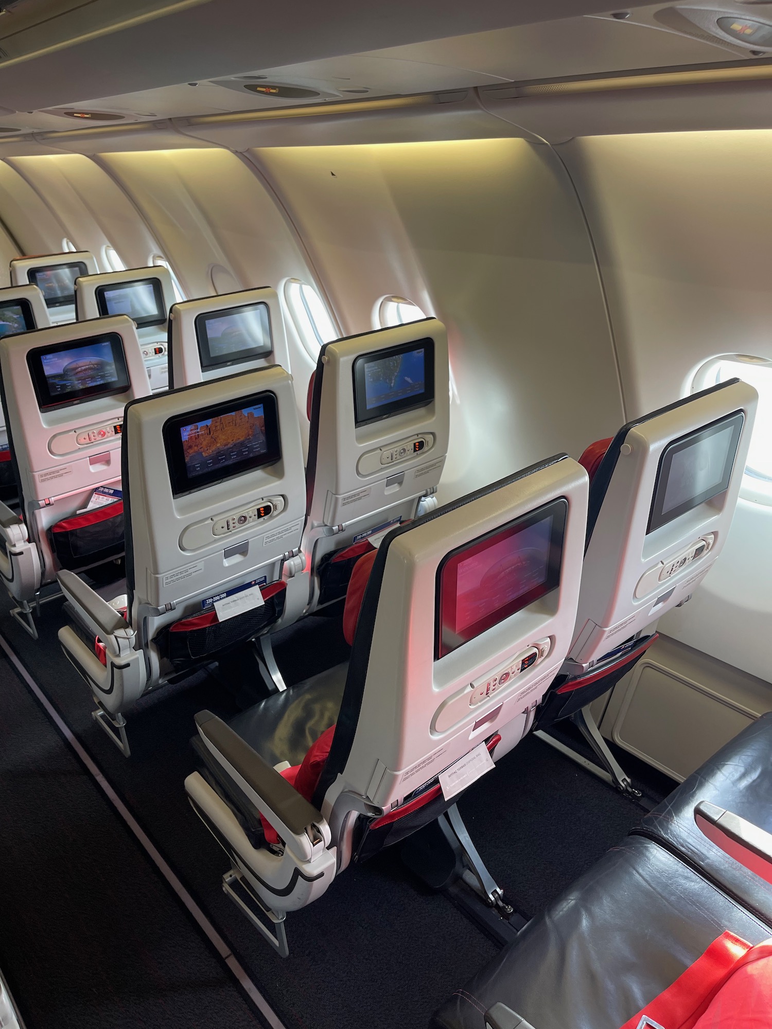 a row of seats with monitors on the side