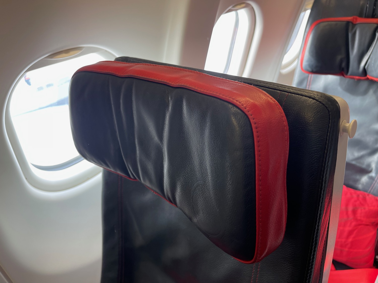 a black and red seat with a red stripe on the back