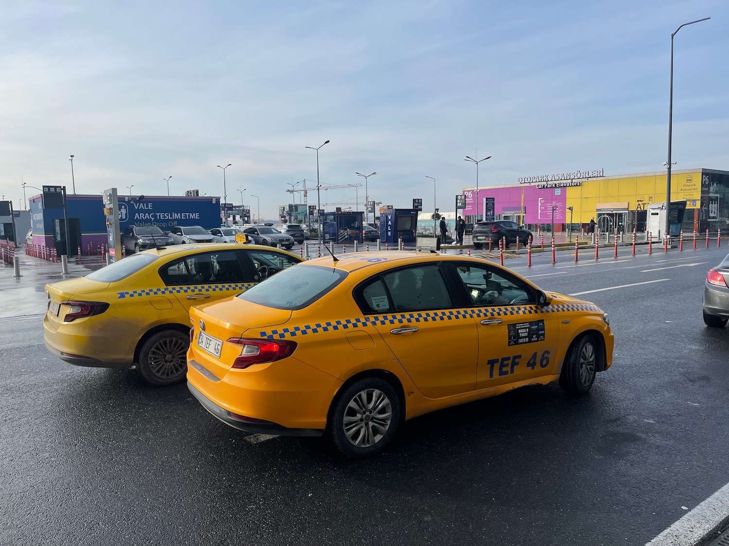 two yellow cars parked on a street