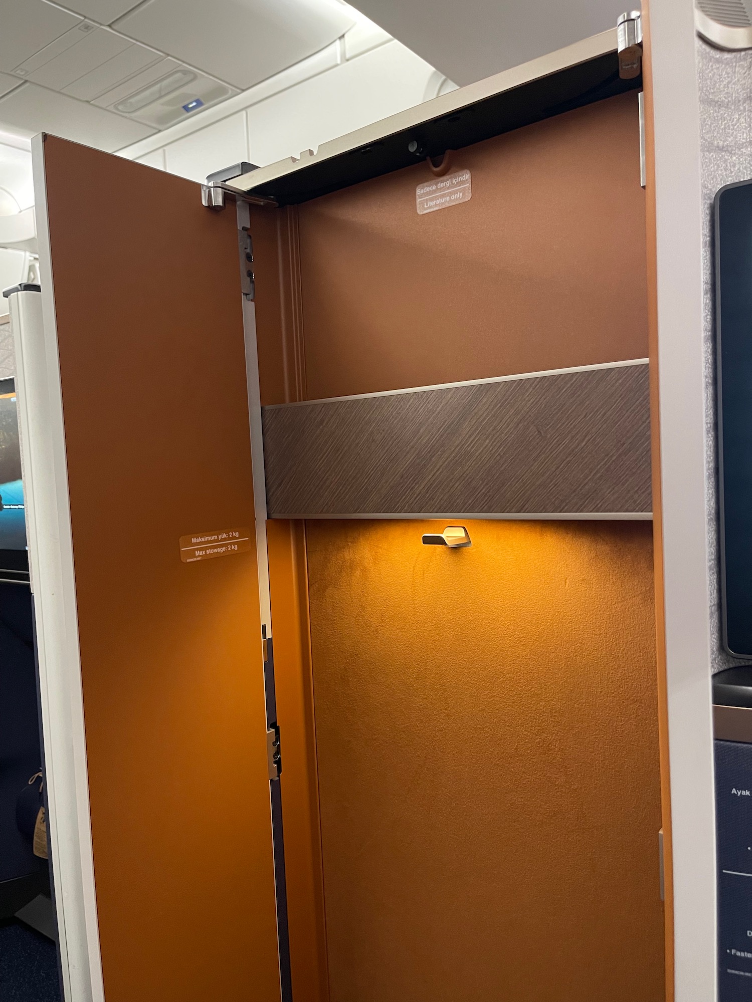 a brown cabinet with a light on it