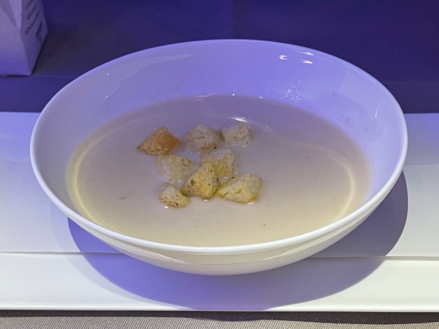 a bowl of soup with croutons