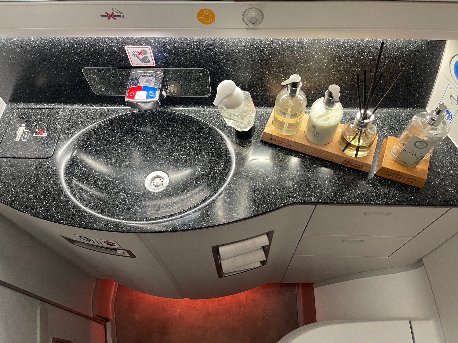 a sink with soap and bottles on it