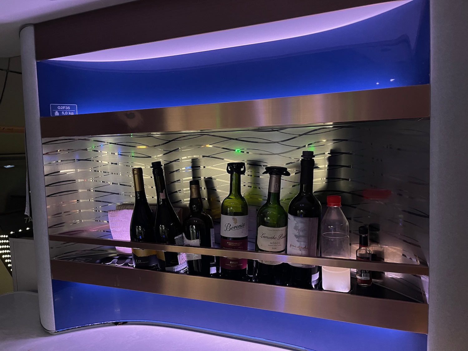 a shelf with bottles of wine