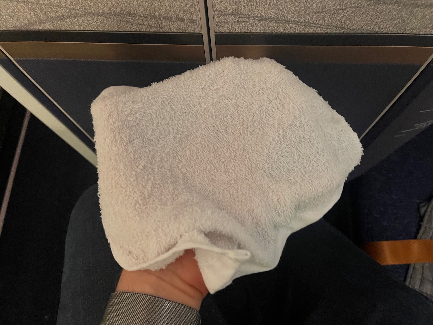 a hand holding a white towel