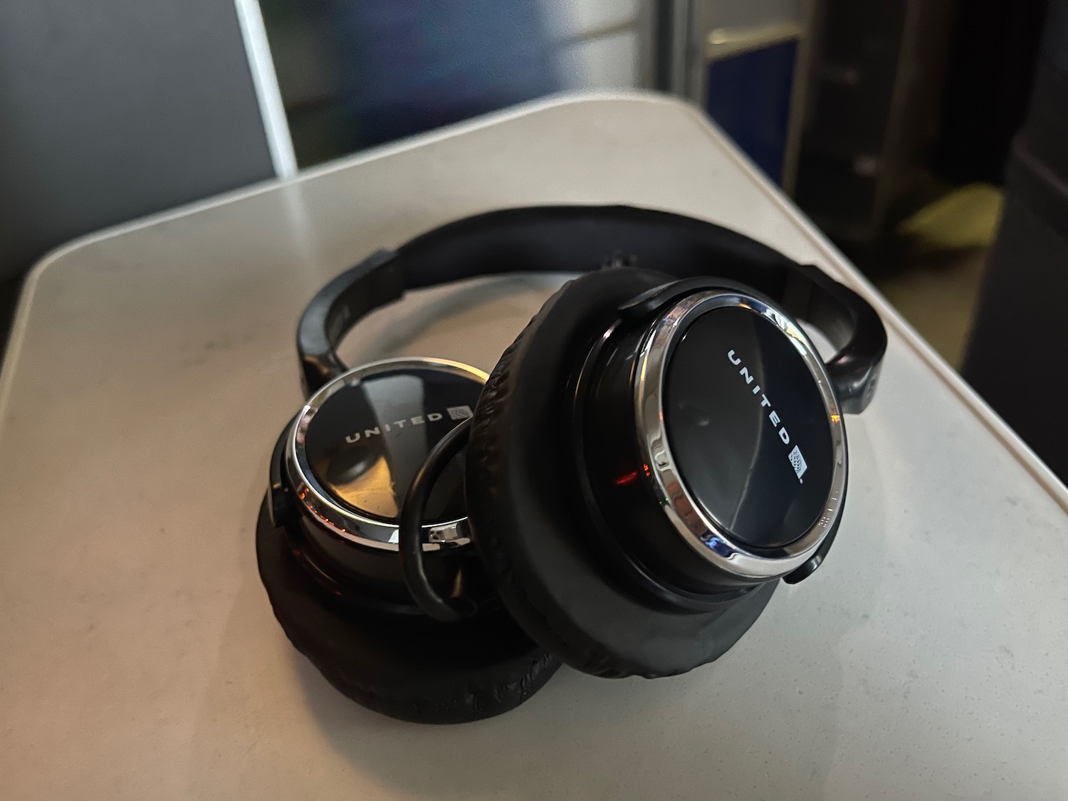 a pair of black headphones on a white surface