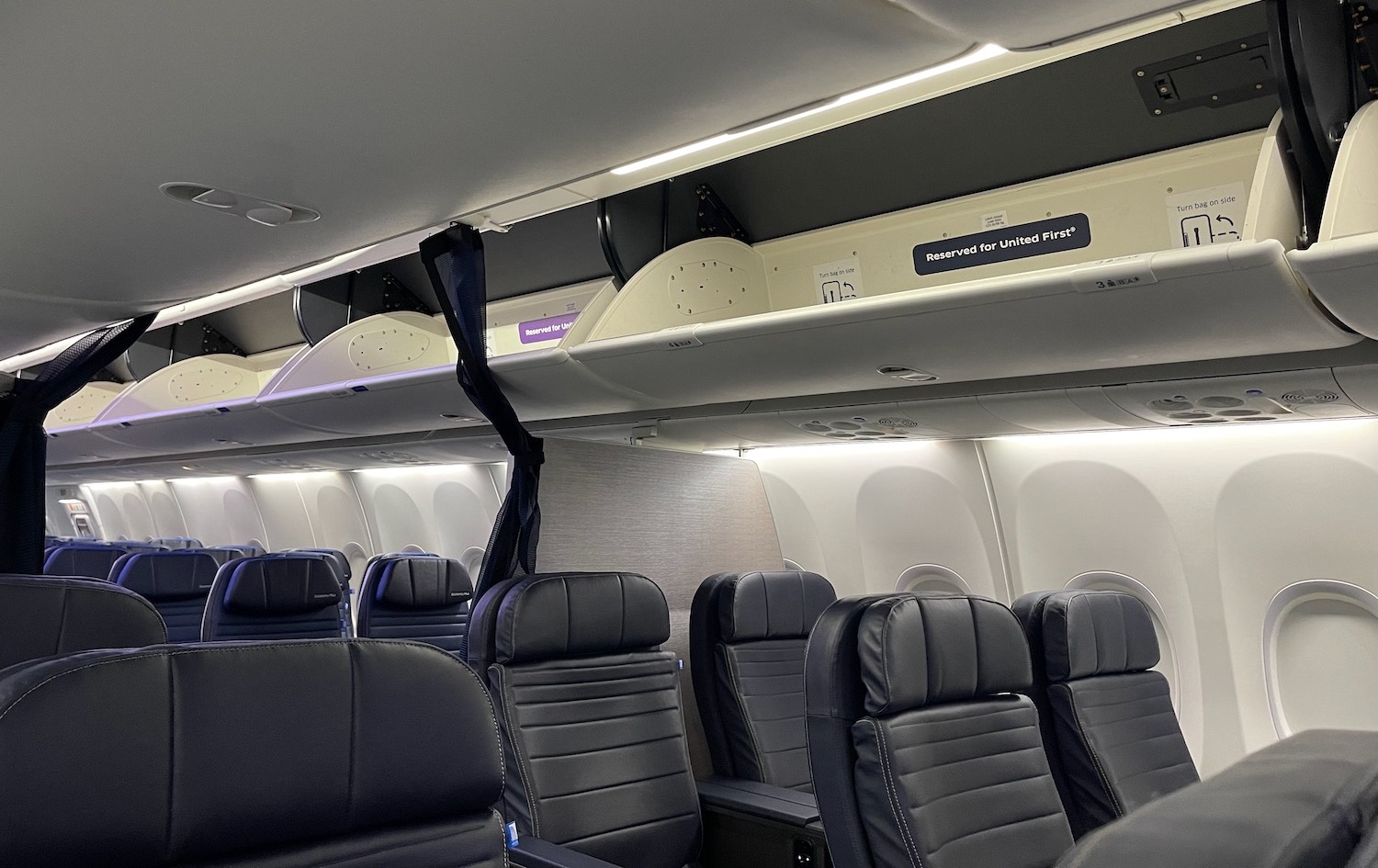 a plane with seats and a shelf