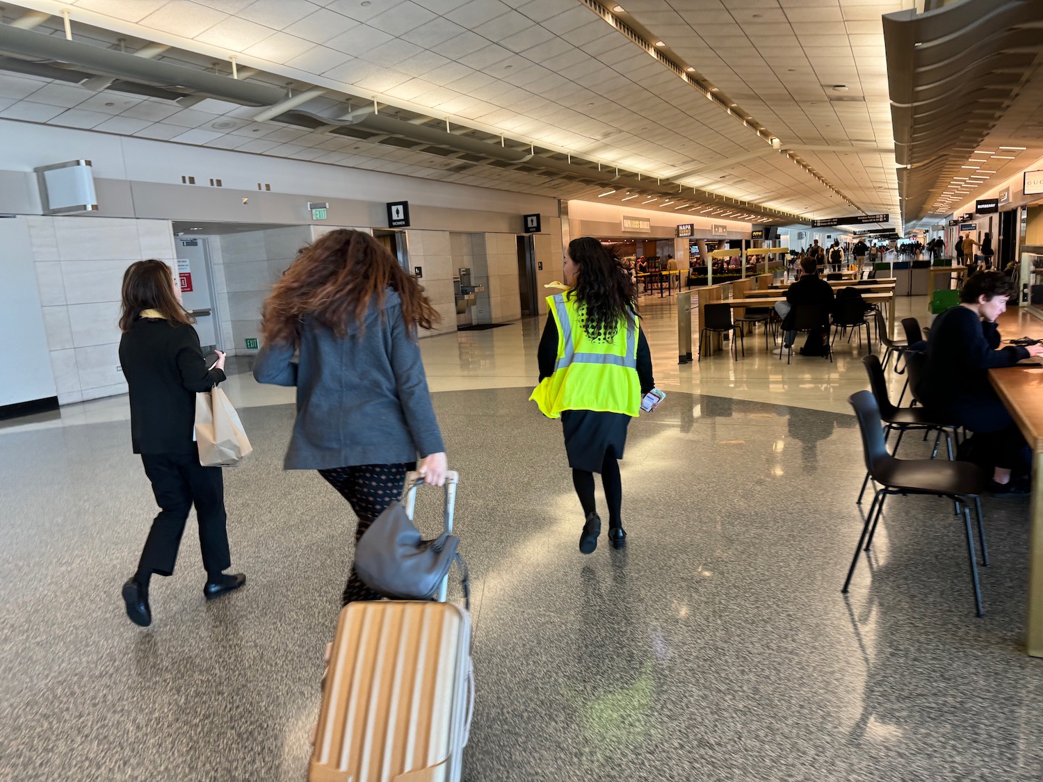 a group of people walking in a airport