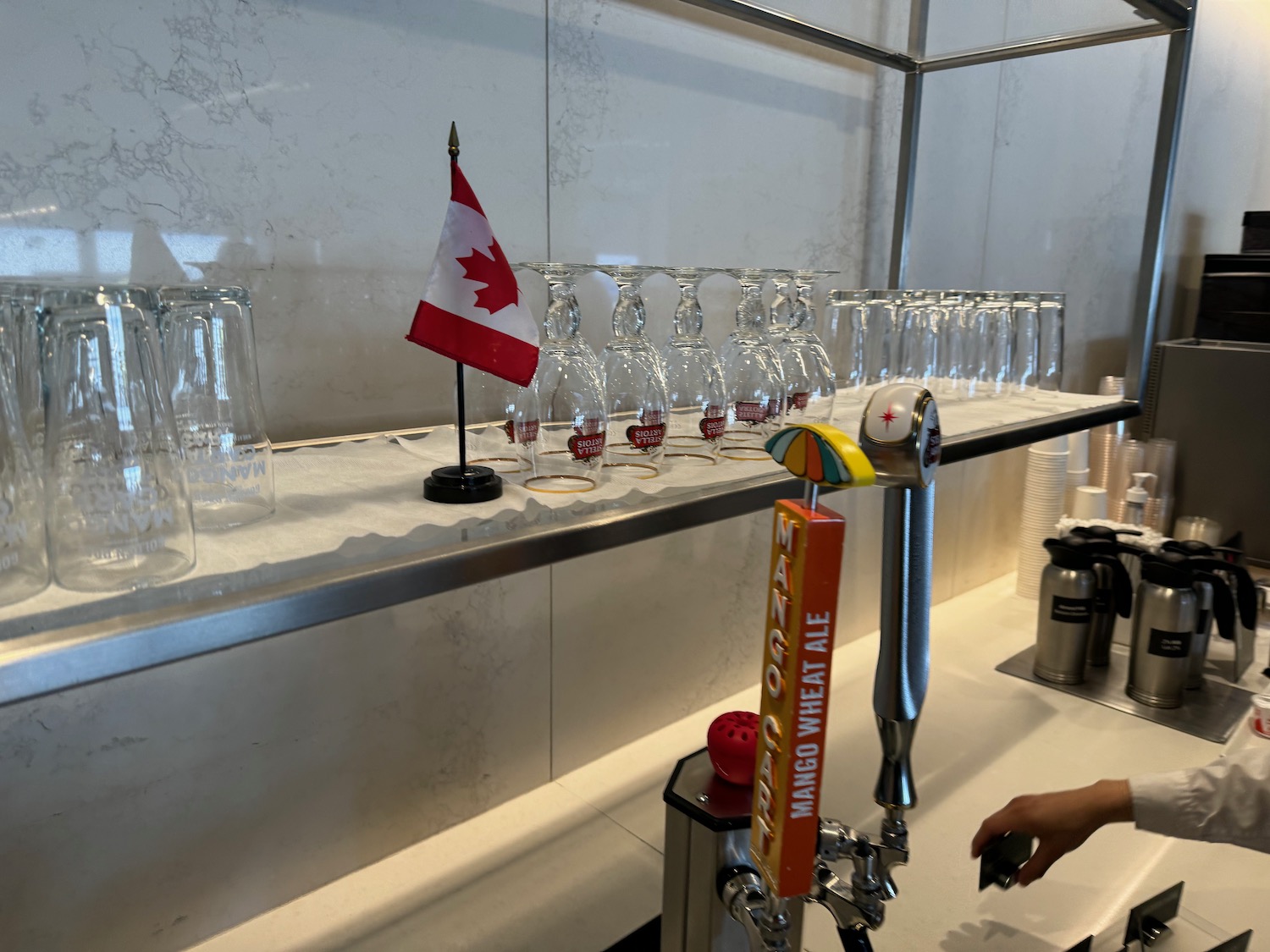 a bar with a row of glasses and a flag