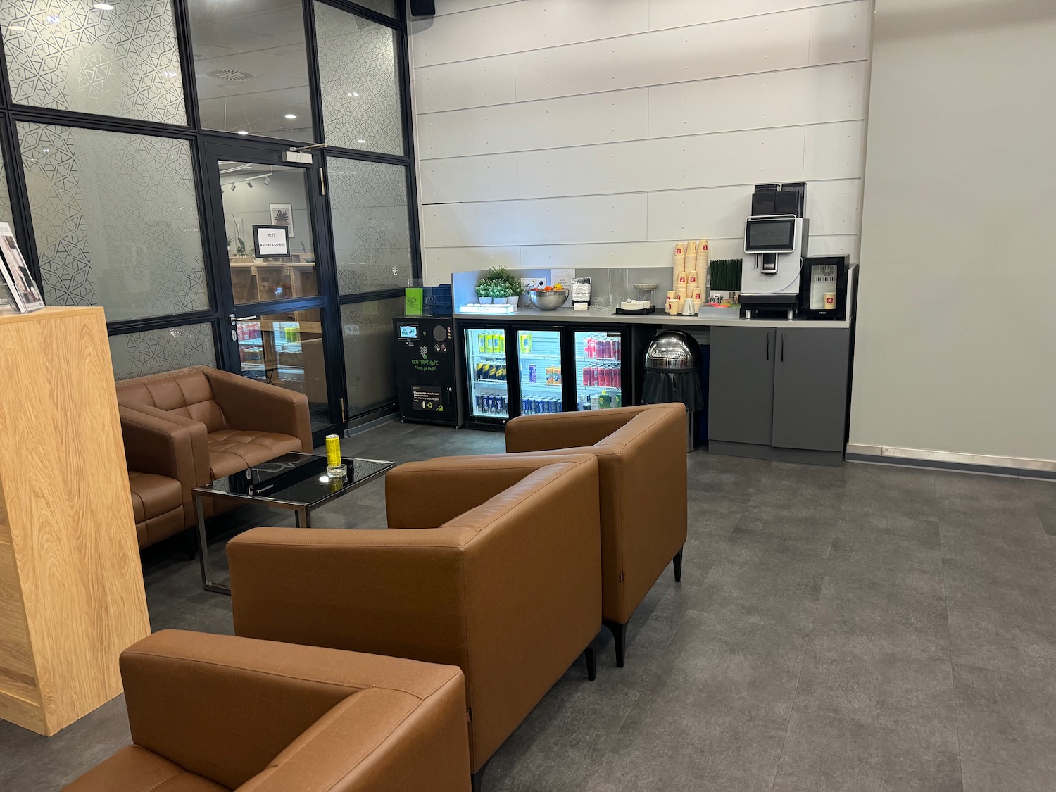 a room with brown chairs and a coffee machine