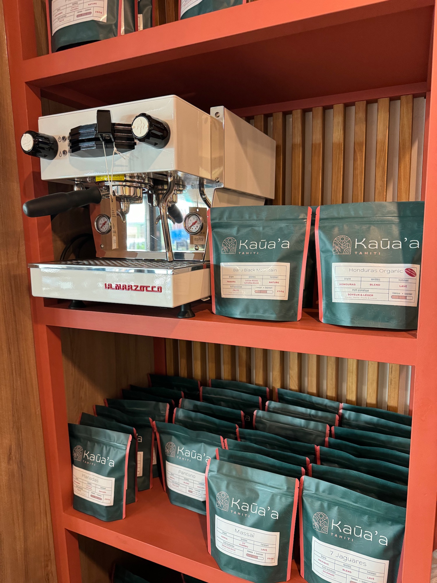 a shelf with coffee machine and bags