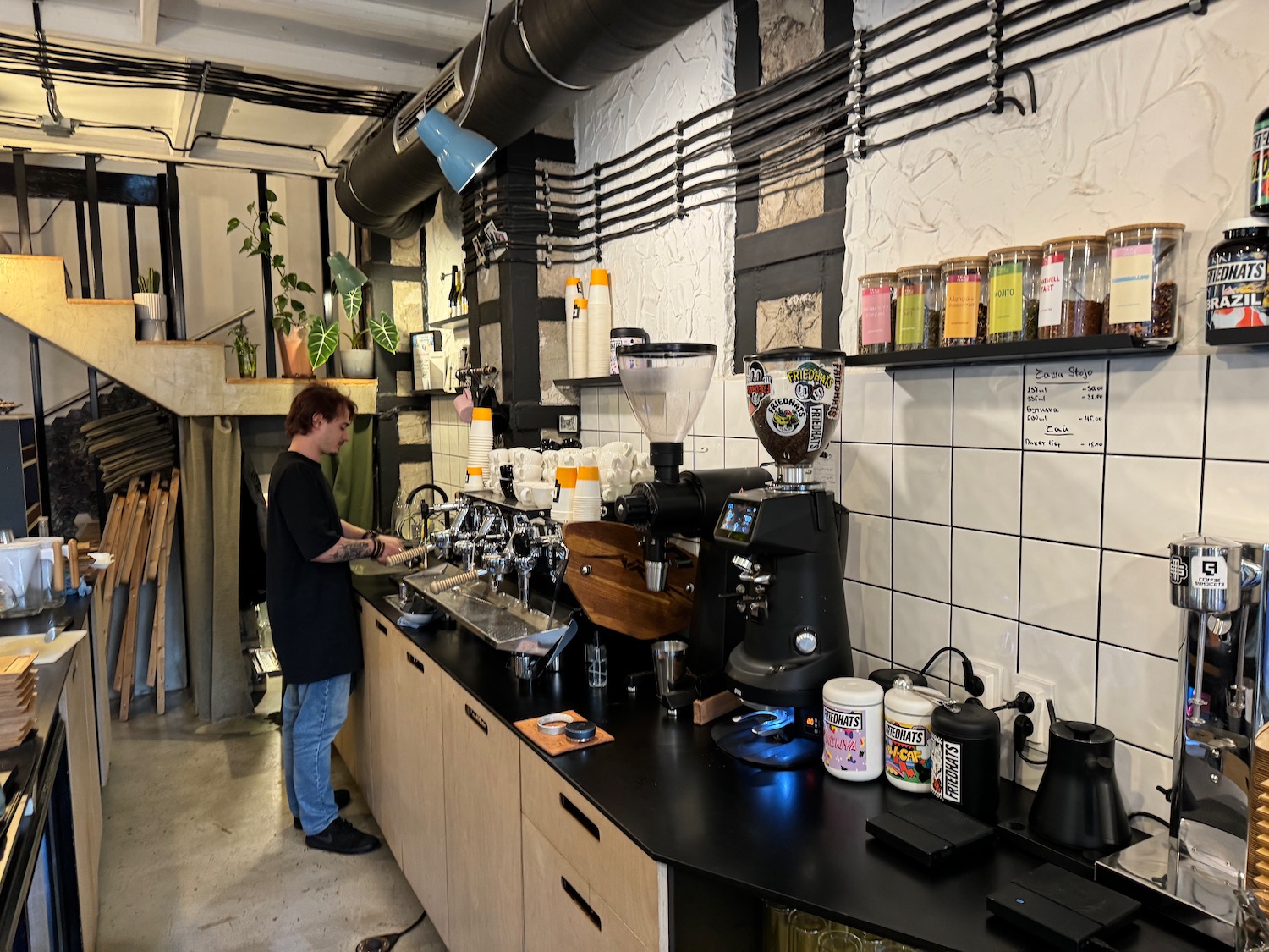 a man standing at a counter in a coffee shop