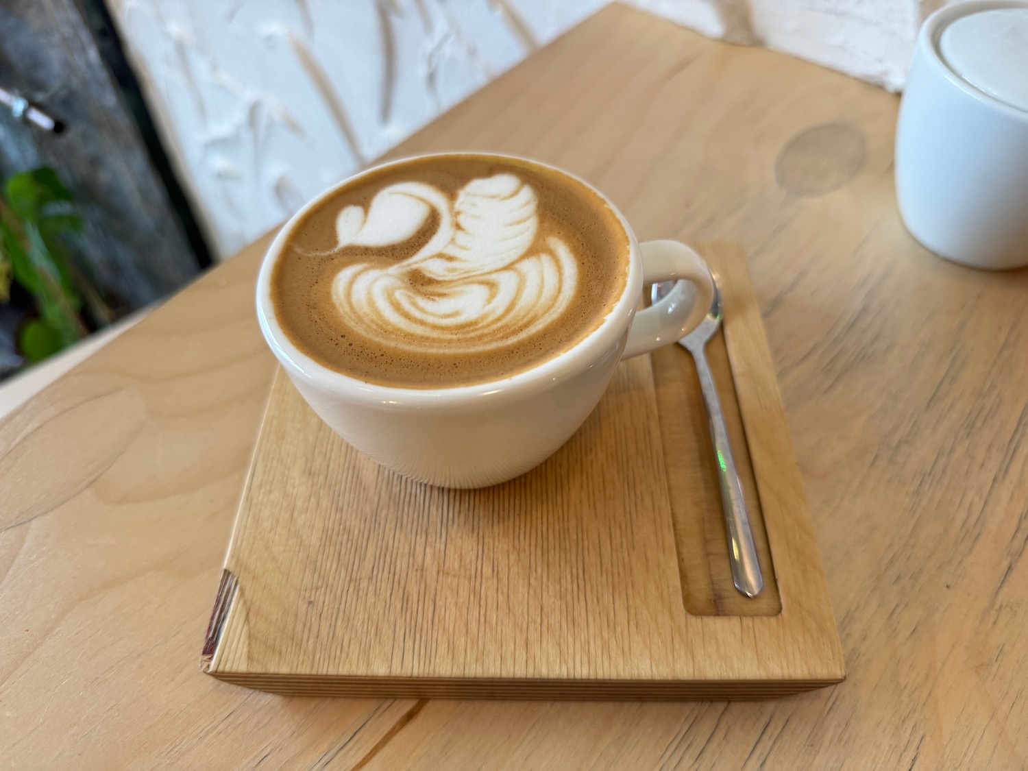 a cup of coffee with a swan design on top