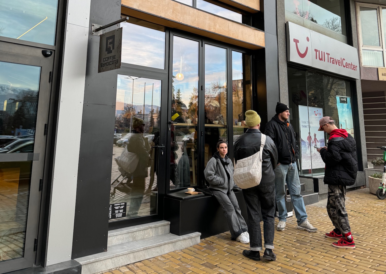 a group of people standing outside a store