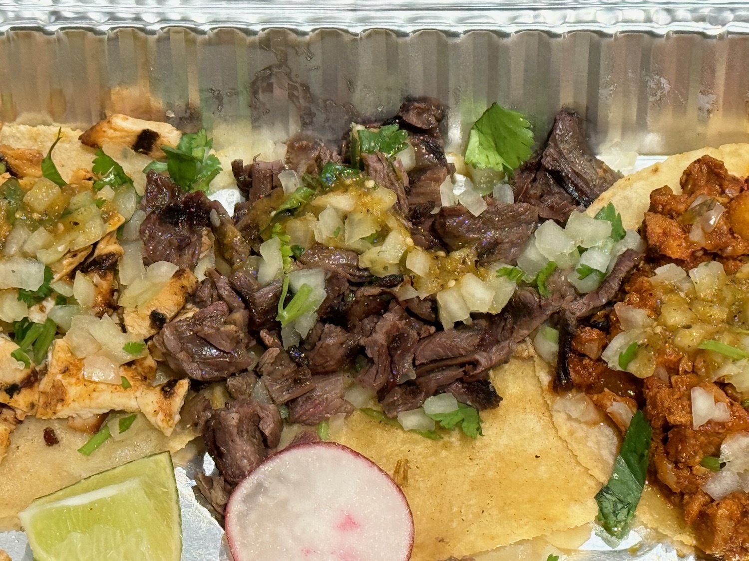 a tray of food with meat and vegetables