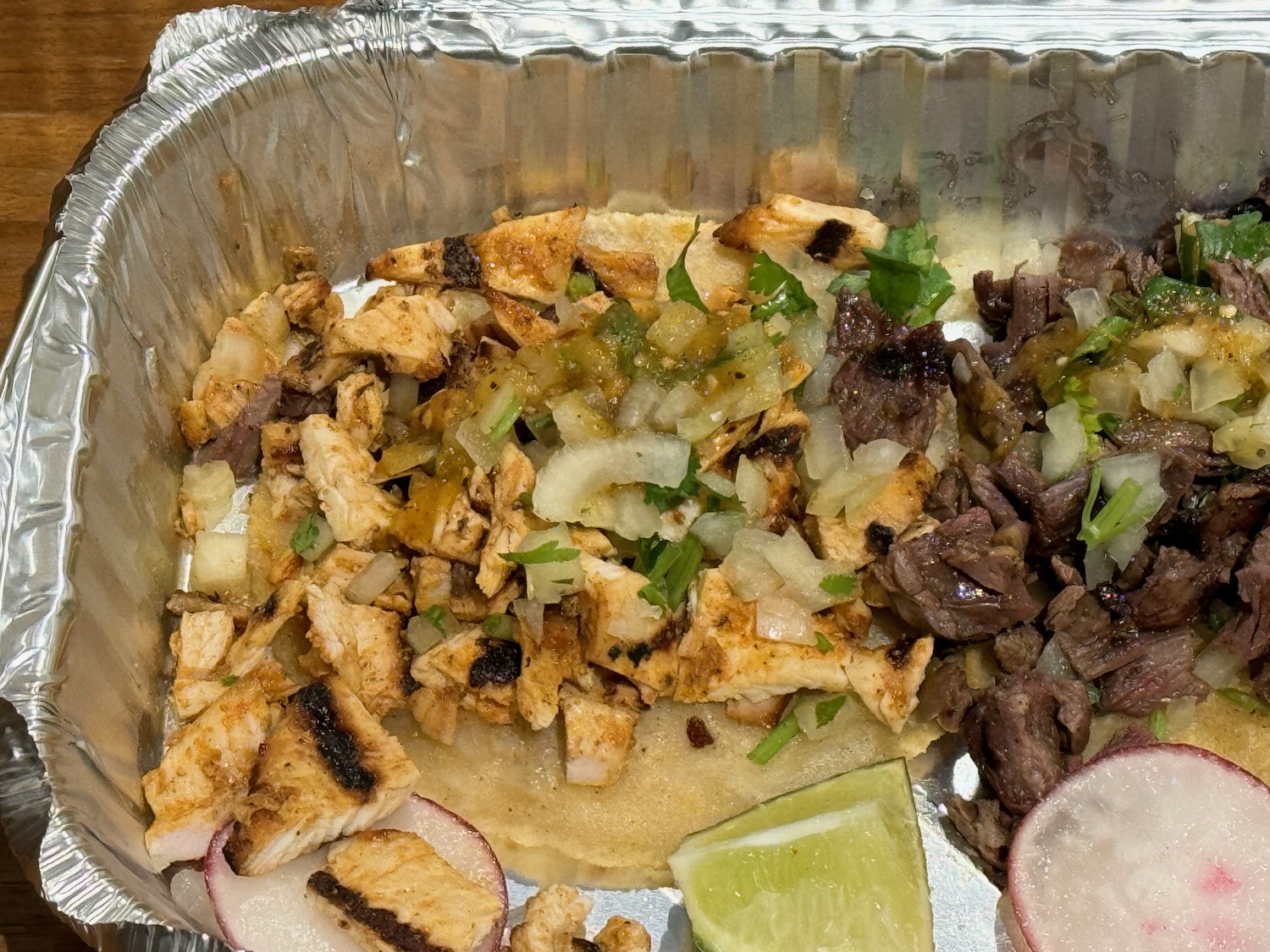 a tray of food with meat and vegetables