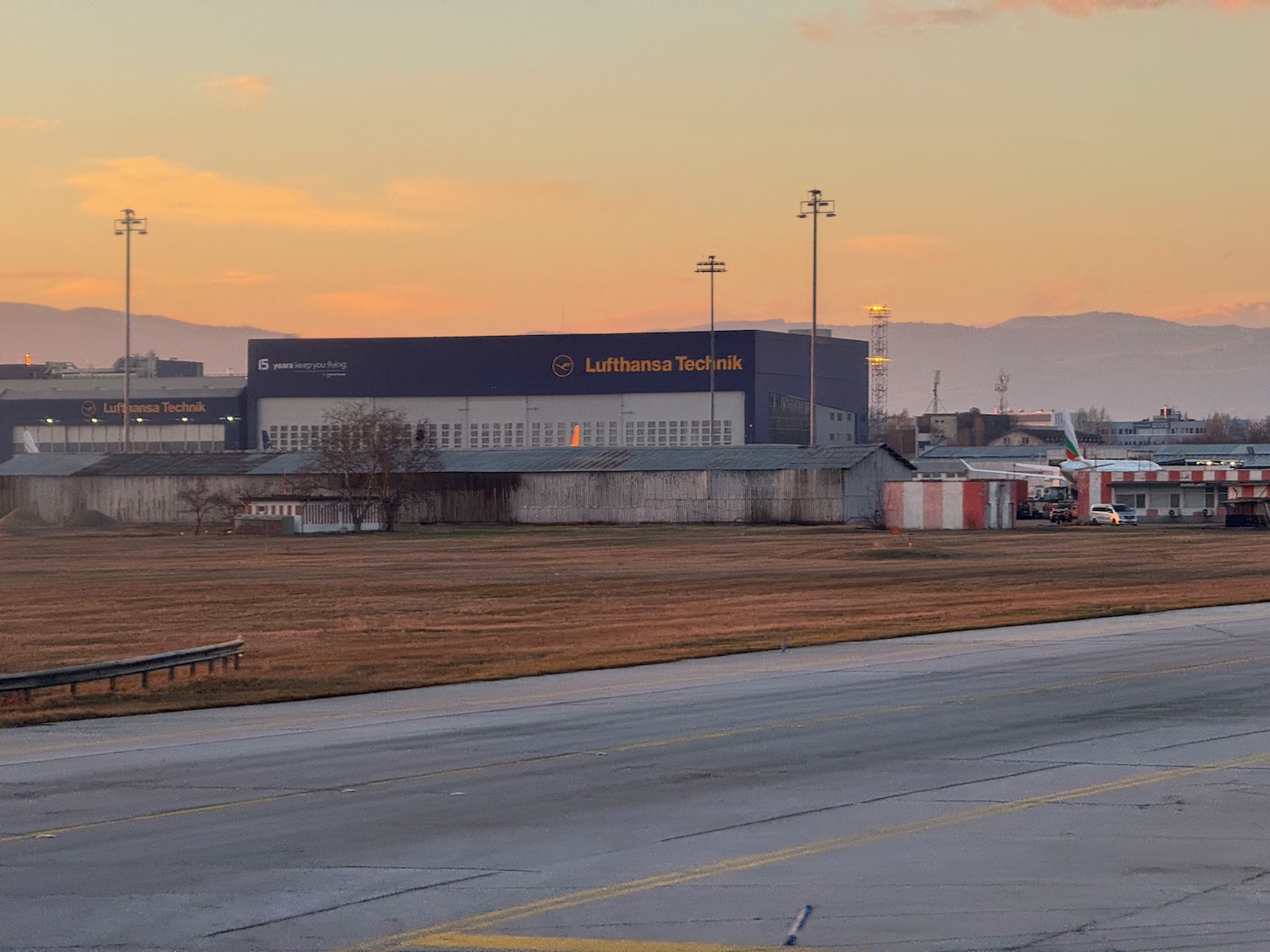 a large building next to a runway