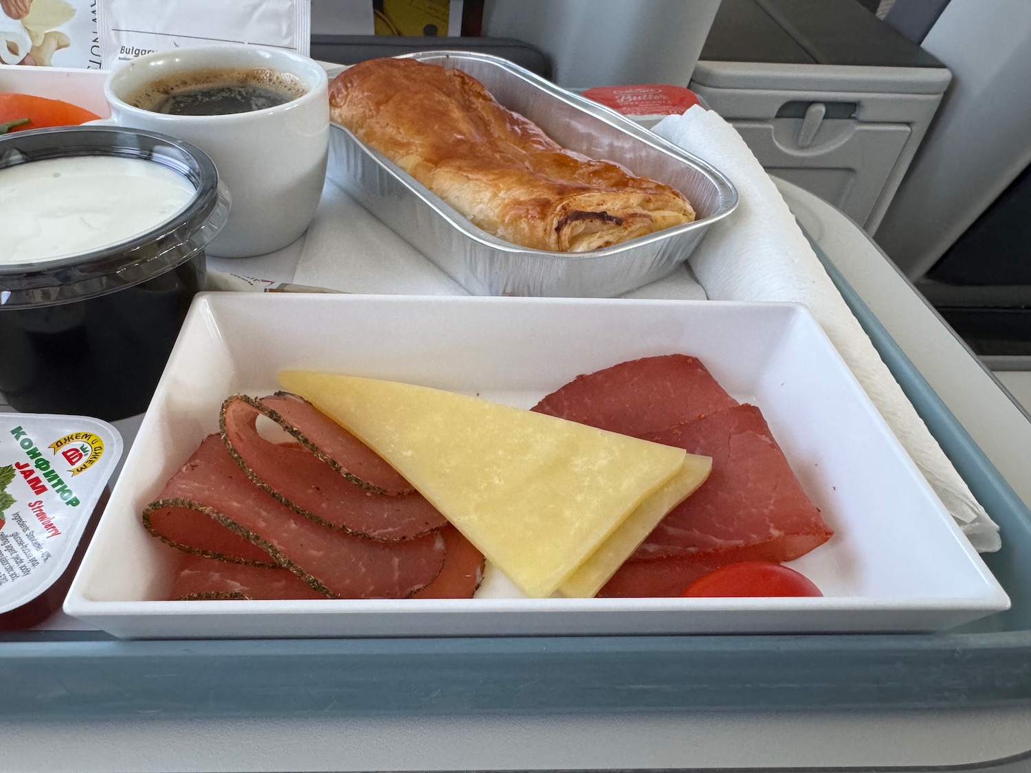 a tray of food and a cup of coffee on a tray