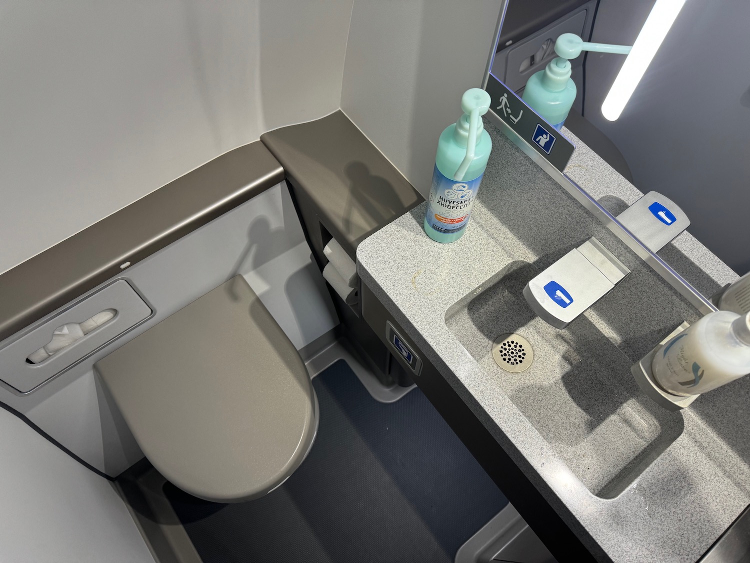 a bathroom with a sink and soap dispenser