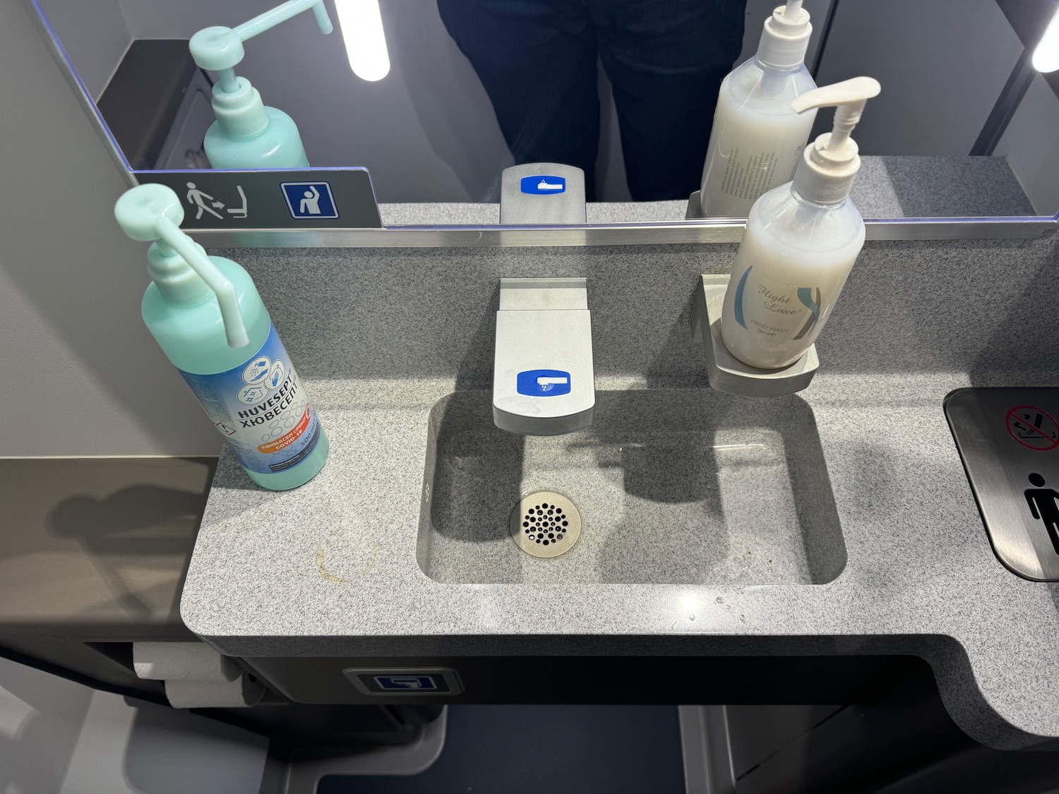 a sink with soap dispensers and bottles