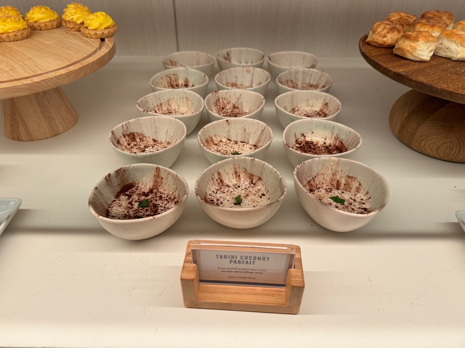 a group of white bowls with brown powder on them