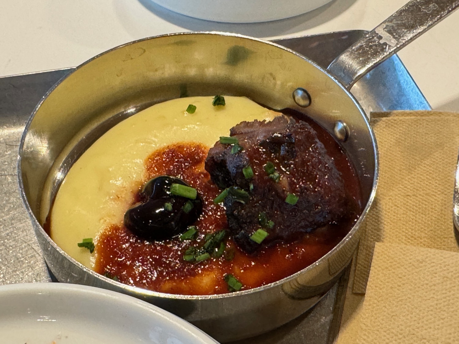 a pot of food with meat and mashed potatoes